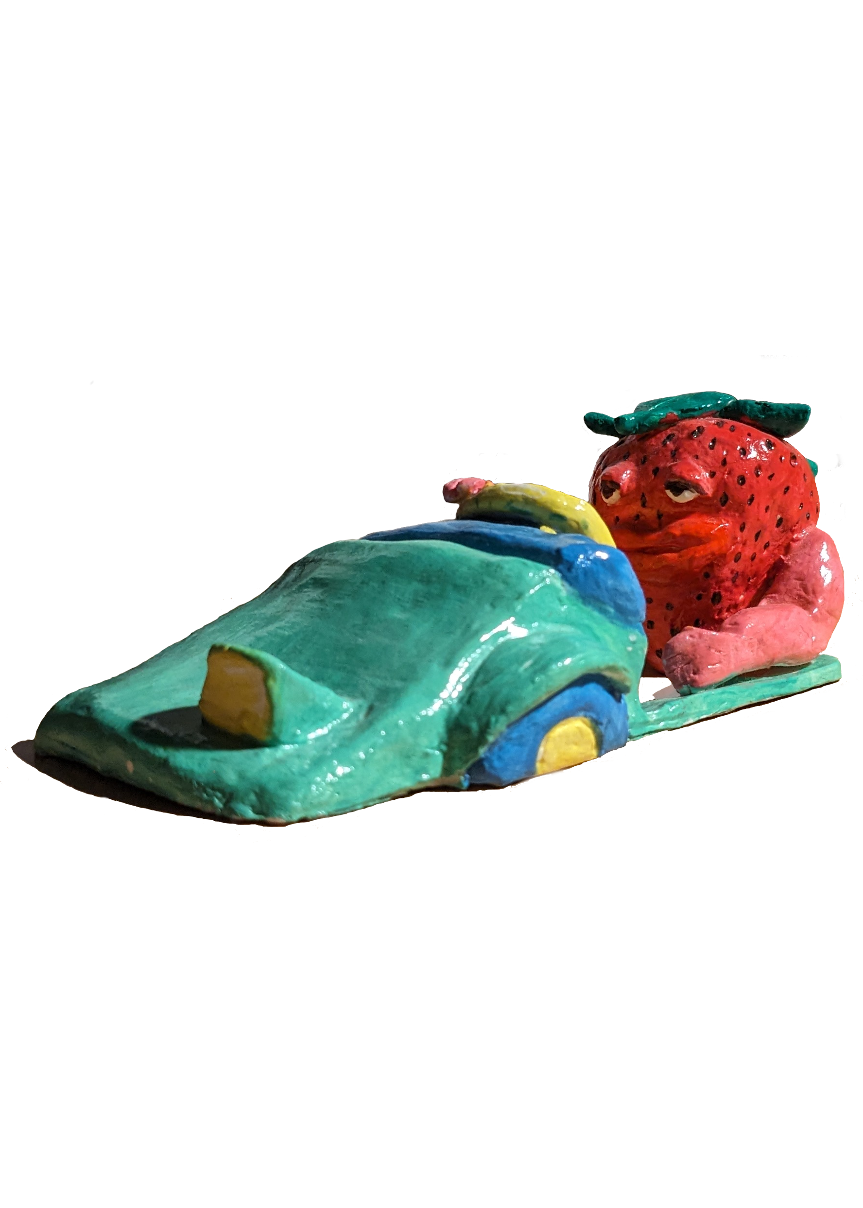 clay sculpture of strawberry driving in a car