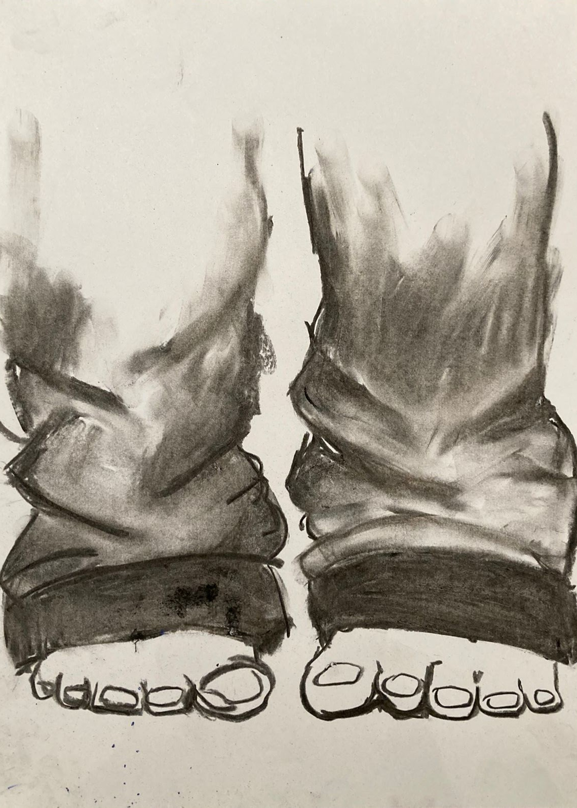 charcoal drawing of baggy jeans and bare feet